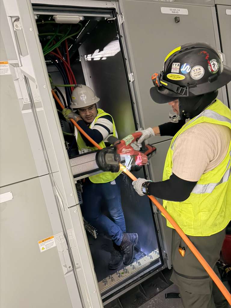 Electrical panel work inside battery manufacturing facility